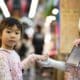 Child holding the hand of a robot.
