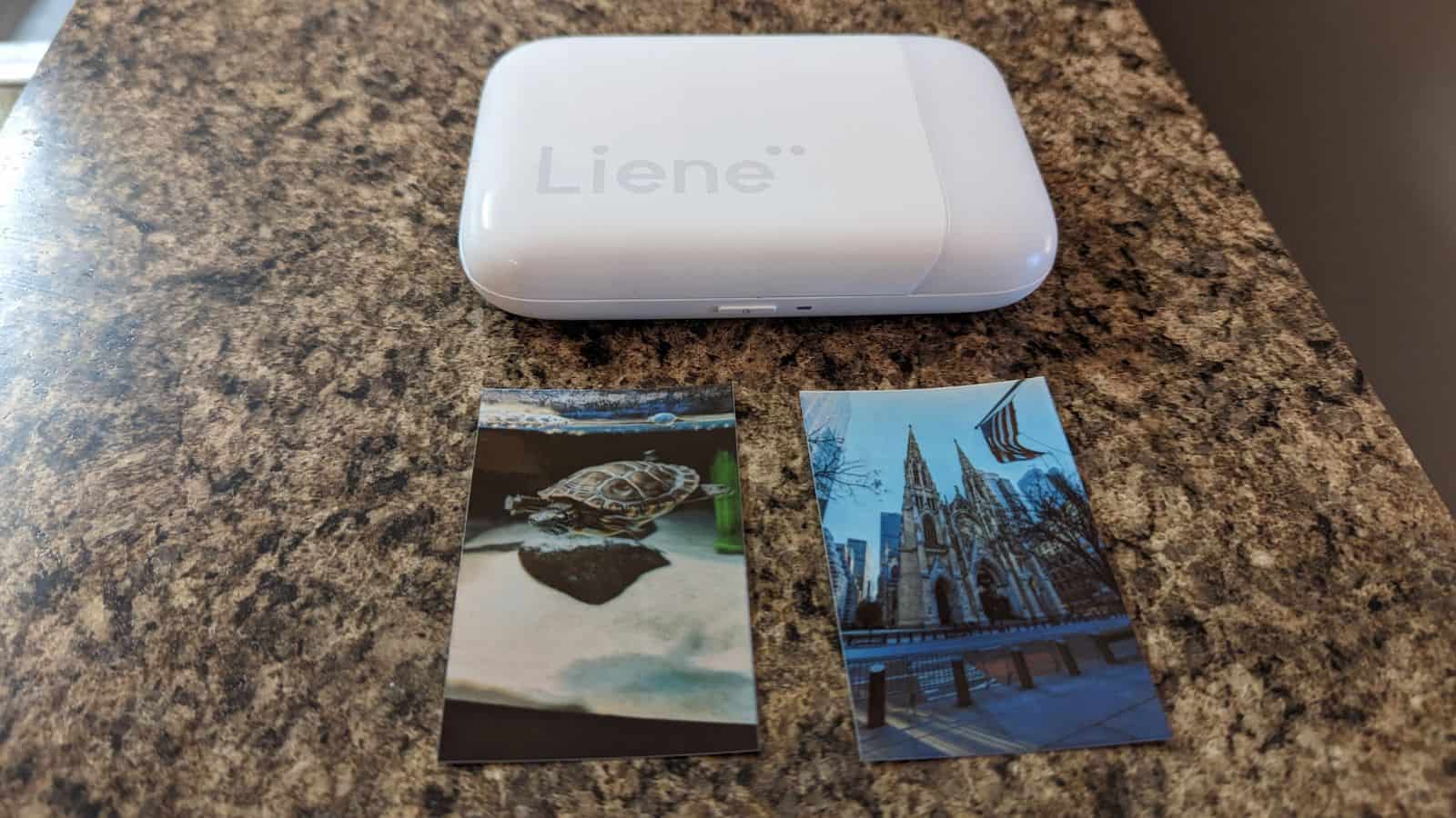 review: liene mini photo printer Liene photo printer on granite counter with printed photos.