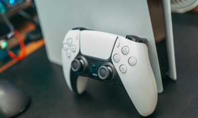 Dualsense controller in front of a playstation 5 console