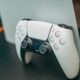 Dualsense controller in front of a playstation 5 console