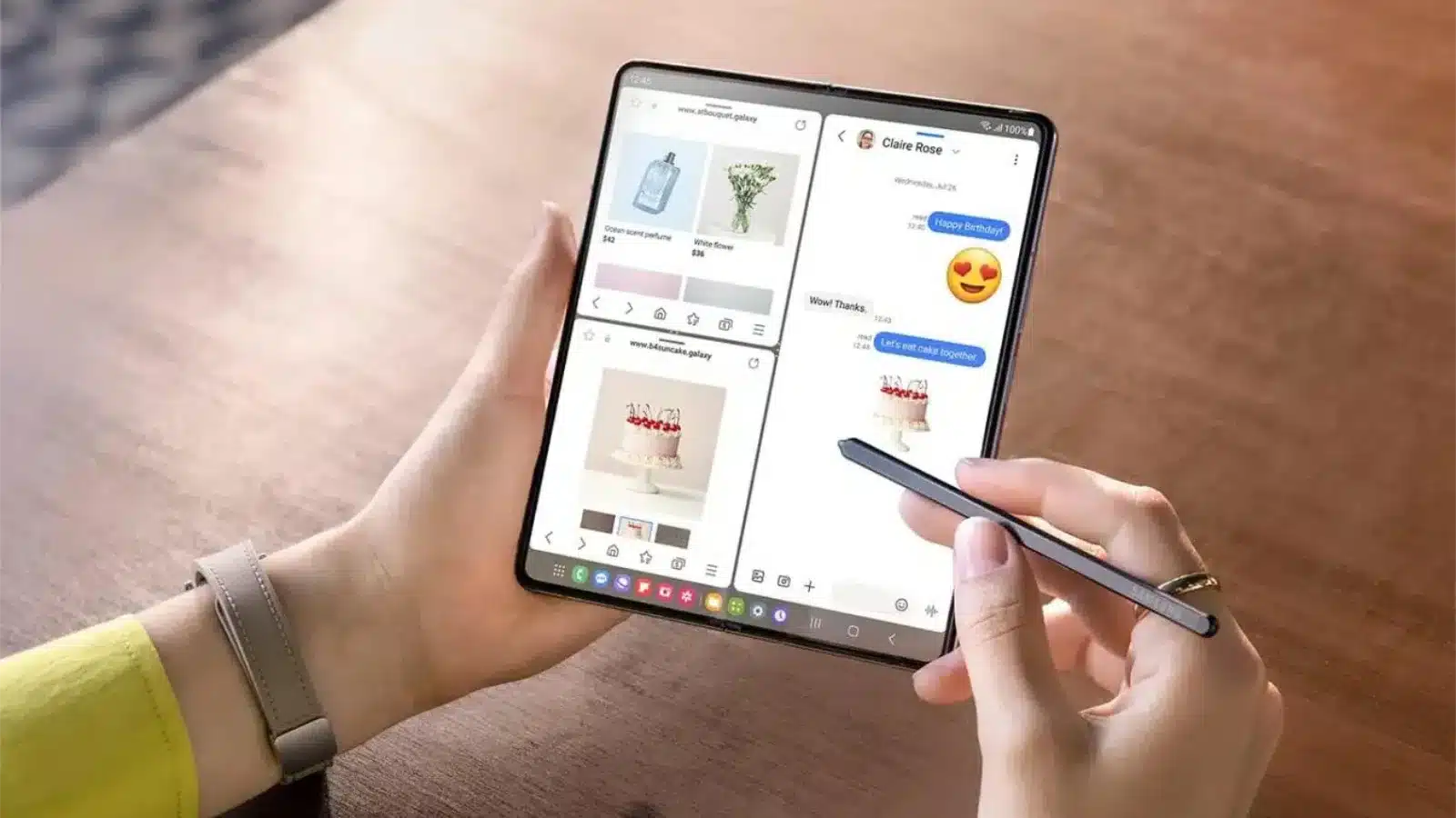 galaxy z fold 5 vs oneplus open: competition is good A person holding a galaxy z fold 5 in their left hand while using their right hand to write on it with the s pen