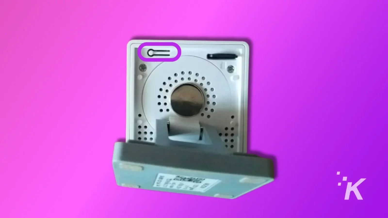 how to fix a wyze camera making noise A metallic silver intercom mounted against a vibrant pink background with a speaker grille, control buttons, and a slot for communication.