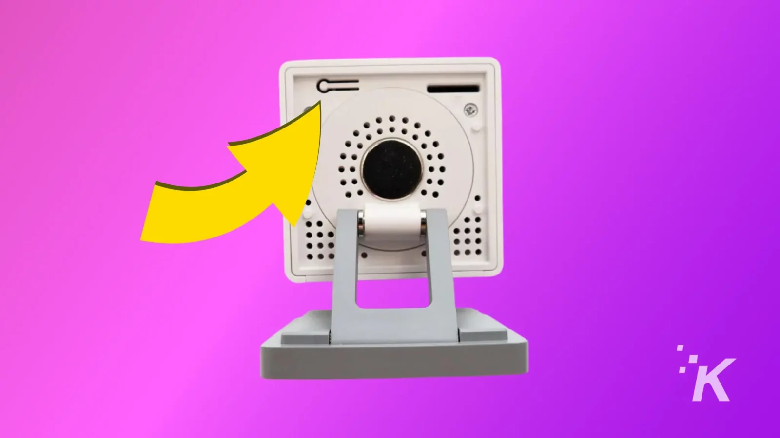 how to transfer a wyze camera to a new owner The image shows a close-up of a white webcam with a large yellow arrow pointing toward it, against a vibrant pink and purple gradient background.