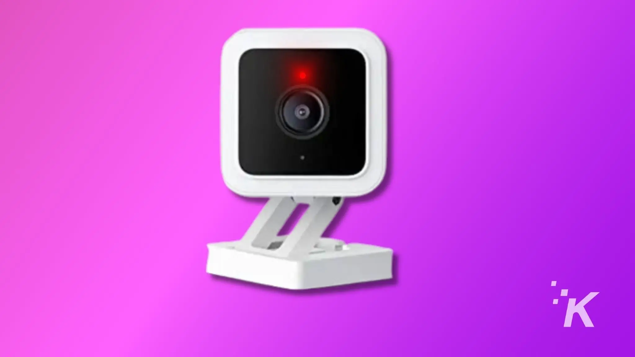how to factory reset a wyze camera before selling it The image features a compact, white security camera against a vibrant pink and violet background. The camera has a glowing red light, signaling activity.